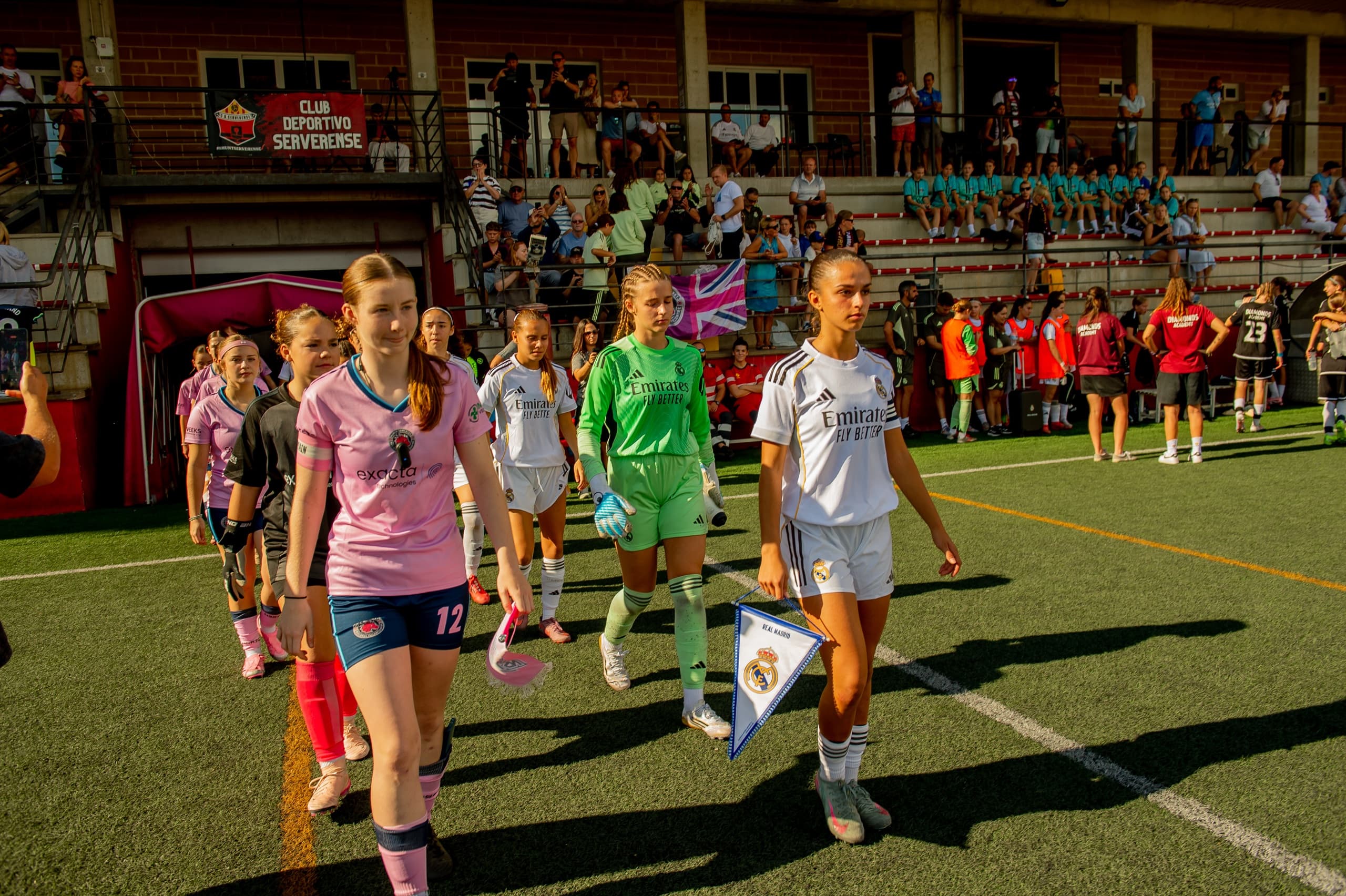 Players walking onto the pitch before a football match.